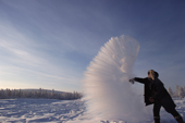 When thrown into cold air at minus 51 degrees Celsius boiling water explodes into vapour & ice. This is because boiling water is close to a gas and breaks into tiny droplets that can freeze at once. Siberia, Russia. 1999