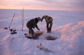 Fisherman check their net set under the ice near Bikovsky. Northern Yakutia, Siberia, Russia. 2001
