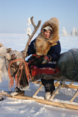 Vikka Piak, a 15 year old Forest Nenets girl, rests on her sled during a reindeer drive.Khanty Mansiysk. Russia. 2000