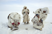 Nenets men check their fish net set under the ice on a lake in the Gydan Peninsula. W.Siberia, Russia. 2000