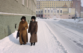 Two warmly dressed young women walking on a street in the centre of Norilsk. Western Siberia. Russia. 2000