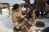 Sergey Serotetto, a Nenets man plays with his daughter, Neseynya, at a meal break during the Spring migration. Yamal. Siberia. Russia. 1993