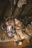 Inside a reindeer skin tent a Anastasia Pulka, a Nenets woman, comforts her baby daughter, Elvira. Yamal, Siberia, Russia