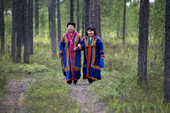 Two Forest Nenets women in traditional summer dress walking in the forest near Tarko-Sale. Purovsky, Yamal, Western Siberia, Russia