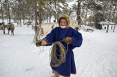 Victor Piak, a Forest Nenets reindeer herder, coils up his lasso at a winter camp in the Purovsky region of the Yamal. Western Siberia, Russia
