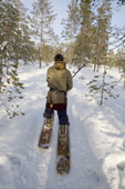 Alexei Piak, a Forest Nenets man, out hunting on skis in the forest during the winter. Purovsky region, Yamal, Western Siberia, Russia