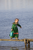 Alona Tokhma, a young Khanty girl, collecting water at a fishing camp on the river Ob near Aksarka. Yamal, Western Siberia, Russia