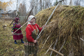 Vera & Irina Purgurchina, two Khanty women, making hay at their home on the bank of the Synya River. Yamal, Western Siberia, Russia