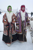 two young Khanty women wearing traditional reindeer skin coats with fox fur collar & decorated with inlaid fur. The one on the right has extensive bead work decoration on the front and shoulders. Salekhard, Yamal, Western Siberia, Russia