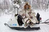 Kosta Kalin, a Selkup hunter, rests on his snowmobile while out checking his sable traps in the forest. Krasnoselkup, Yamal, Western Siberia, Russia. (2012)