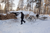 Selkup hunters returning to their 'Poymot' (traditional Selkup turf hut) at a winter hunting camp in the forest near Ratta. Krasnoselkup, Yamal, Western Siberia, Russia. (2012)