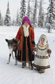 At a Khanty reindeer herder's winter camp, Katya Ozelova poses with her daughter Angelina, and a young avka (pet reindeer). Shuryshkarsky Region, Yamal, NW Siberia, Russia