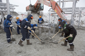 Workers dressed against the winter cold at the construction site of an airport terminal building near Sabetta in the South Tambey gas field. Yamal Peninsula, NW Siberia, Russia