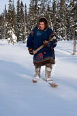 Eduard Khudi, a Nenets reindeer herder, carries an axe as he skiis into the forest to chop firewood near his winter camp. Yamal, Northwest Siberia, Russia