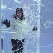 Woman behind an ice wall in the Ice Hotel. Jukkasjarvi, Kiruna, Lapland, Sweden. MR