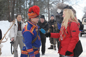 Sami reindeer herder gives press interview at the Jokkmokk Winter Market. Sweden. Size to A4