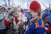 Sami reindeer herder in conversation with the wild man of the Jokkmokk Winter Market (Vild-Hasses meats). Sweden.