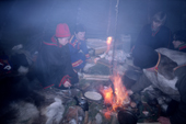 Sami cook inside a smokey tent (lavvu) at the Jokkmokk Winter Market. Sweden