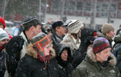 Spectators stand in the snow to watch the reindeer races at Jokmokk Winter Market. Sweden. Size to A4