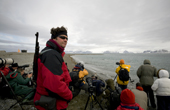 Man with rifle guards the photographers from Polar Bears. They are photographing walrus. Prins Karls Forland. Spitsbergen.
