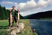 Michael Smith holds 2 large salmon he has caught on the Farleyer Beat, on the River Tay. Perthshire.