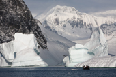 Zodiacs cruise amongst icebergs off Booth Island. Antarctica