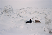 An Inuit hunter drives his snowmobile through rough tidal ice near George River. Ungava Bay, N.Quebec, Nunavik, Canada