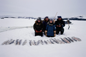 An Inuit family from George River, Kangiqsualujjuaq, with their catch of Arctic Char & Trout. Ungava Bay, N. Quebec, Canada.