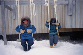 Inuit children playing on swings outside a house in George River, Ungava Bay, N.Quebec, Nunavik, Canada.
