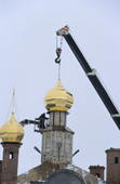 Putting a gold dome on the church being built in the city of Nadym. Yamal, Siberia, Russia.