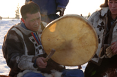 A Chukchi man playing a shaman's drum. Northern Siberia, Russia.